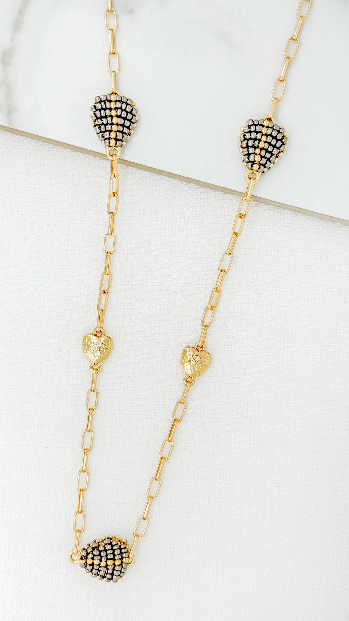 Envy Long gold necklace with textured and beaded hearts