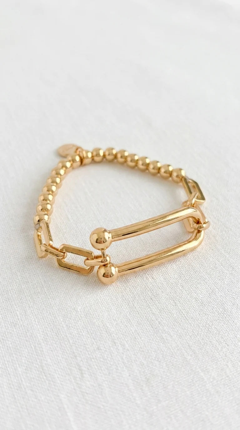 Envy Bracelet Gold beaded elasticated bracelet with bar design